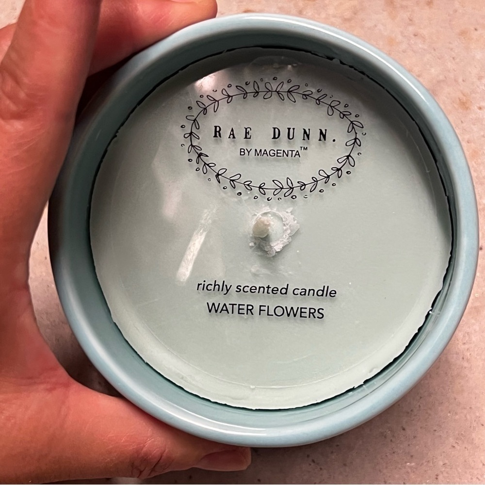 RAE DUNN citronella water blossom candle in a reusable blue planter